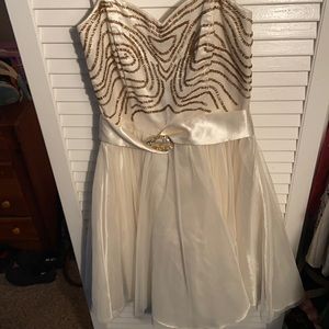 Short strapless cream dress with gold beads.